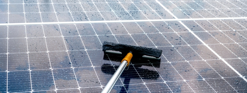 Cleaning Solar Panel With Microfiber Mop On Wet Roof. Solar Pane